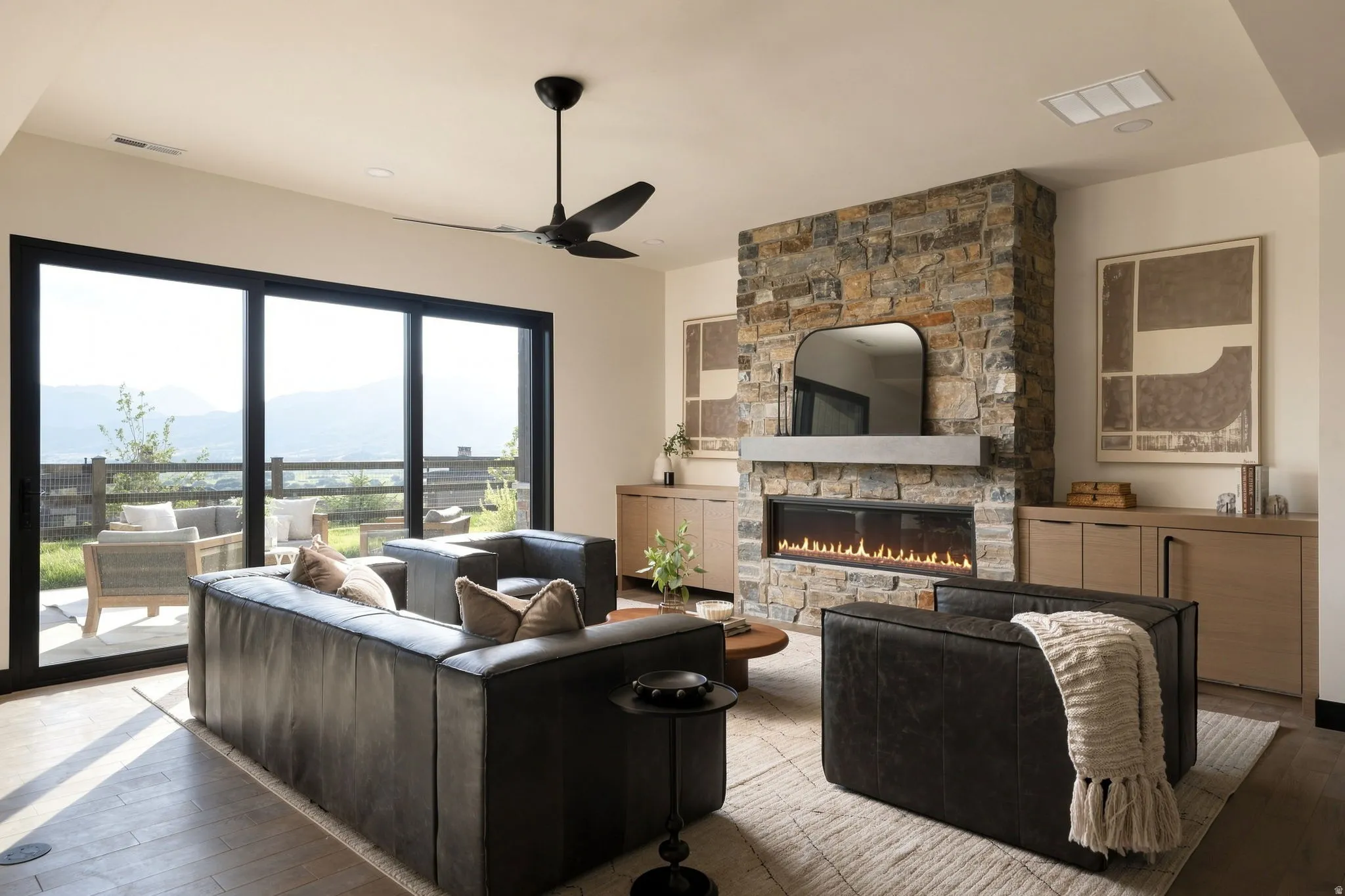 Stone-clad fireplace with a linear insert and concrete mantel