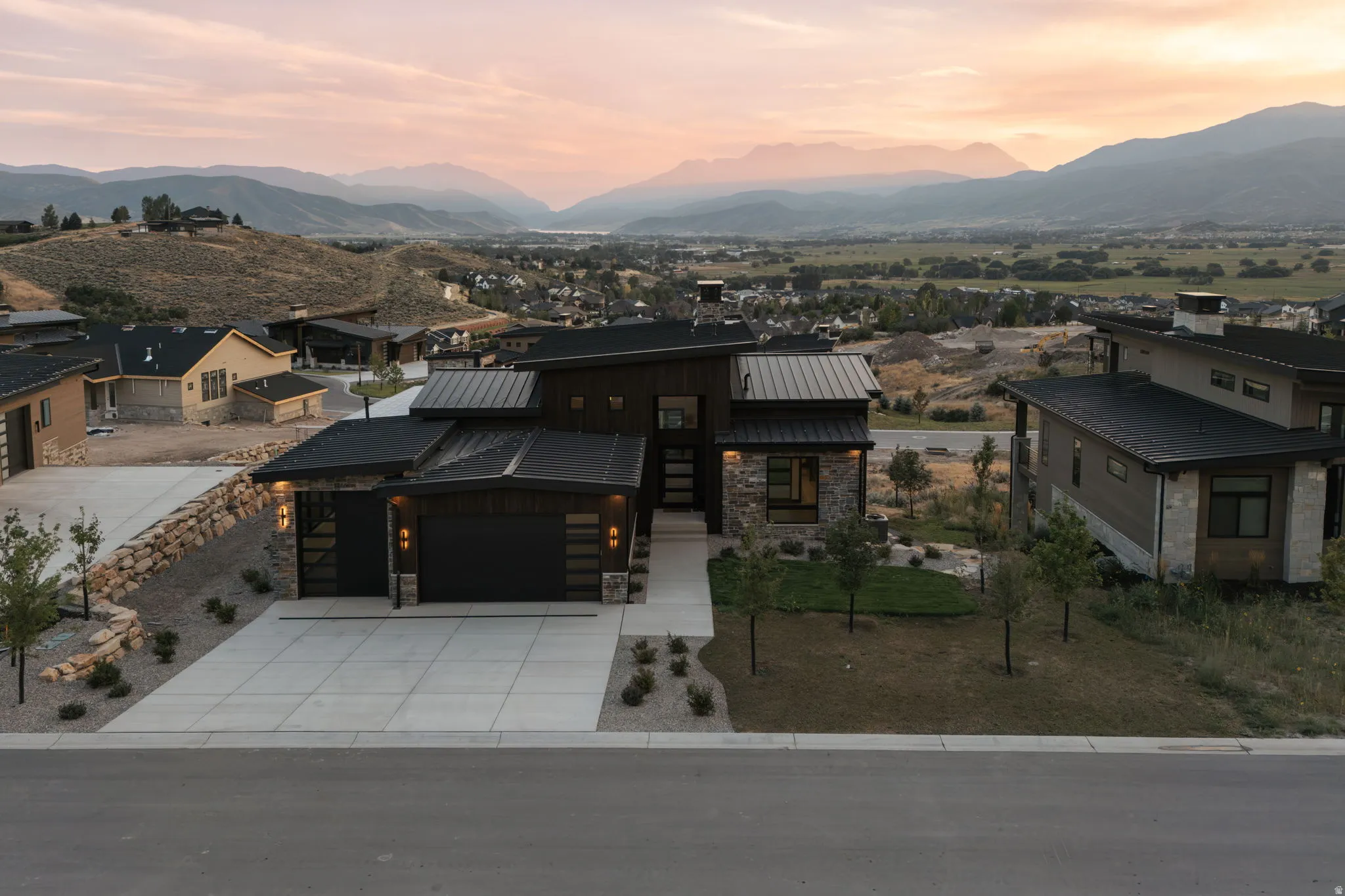 Contemporary exterior with metal roofing and stone accents