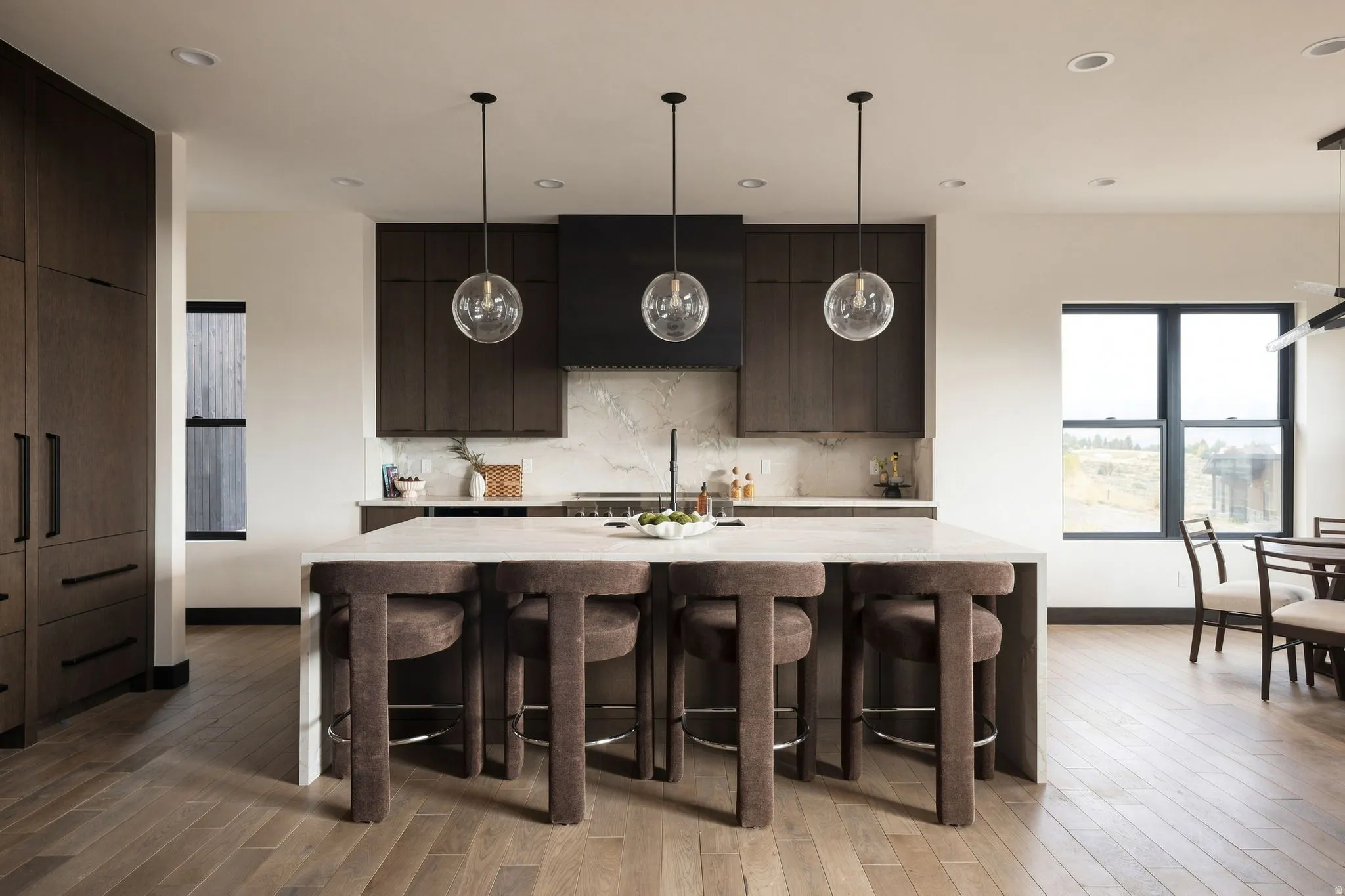 Kitchen island with a light-toned countertop and pendant lighting