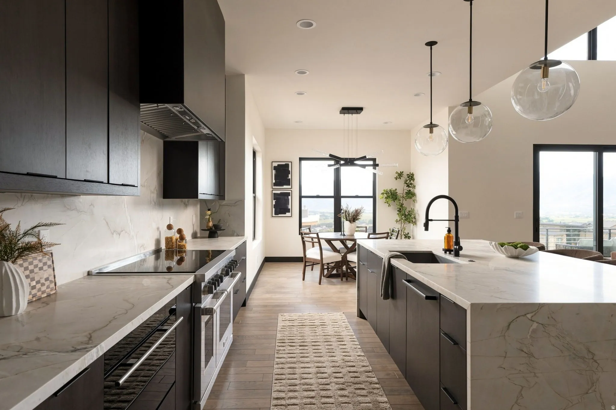 White countertops with integrated backsplash, dark wood-finish cabinetry, stainless steel range with overhead hood, and a kitchen island with an undermount sink