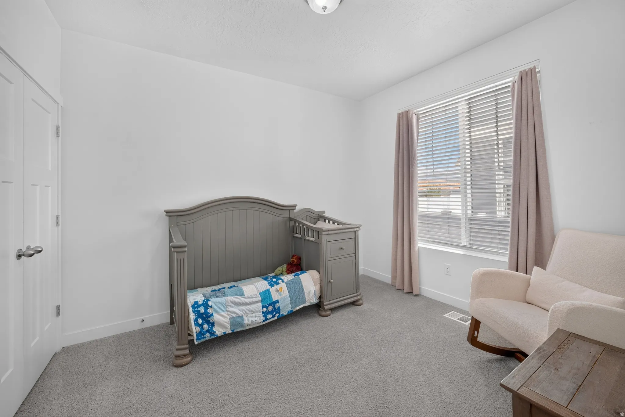White walls with gray carpet flooring