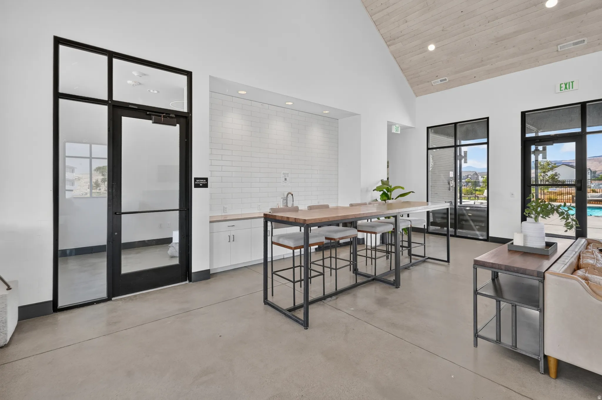 Polished concrete flooring with a vaulted wood-paneled ceiling