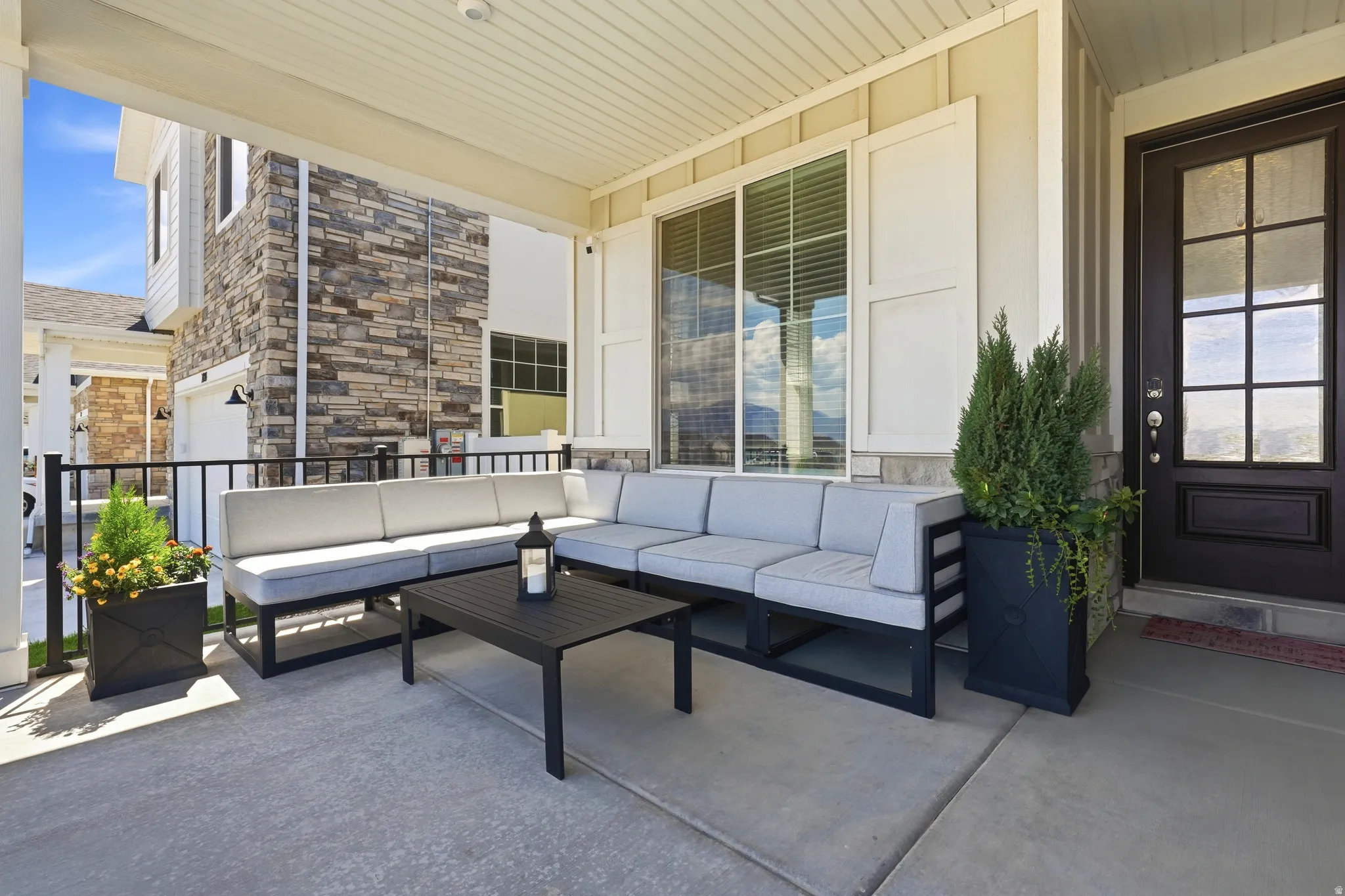 Covered patio featuring a concrete surface and black metal railing