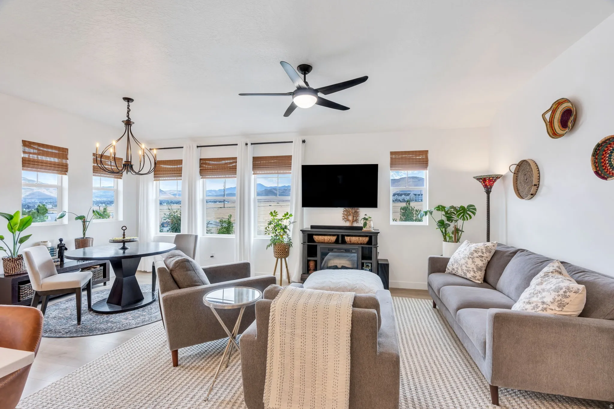 Open-concept living space featuring multiple windows, a ceiling fan, and recessed lighting