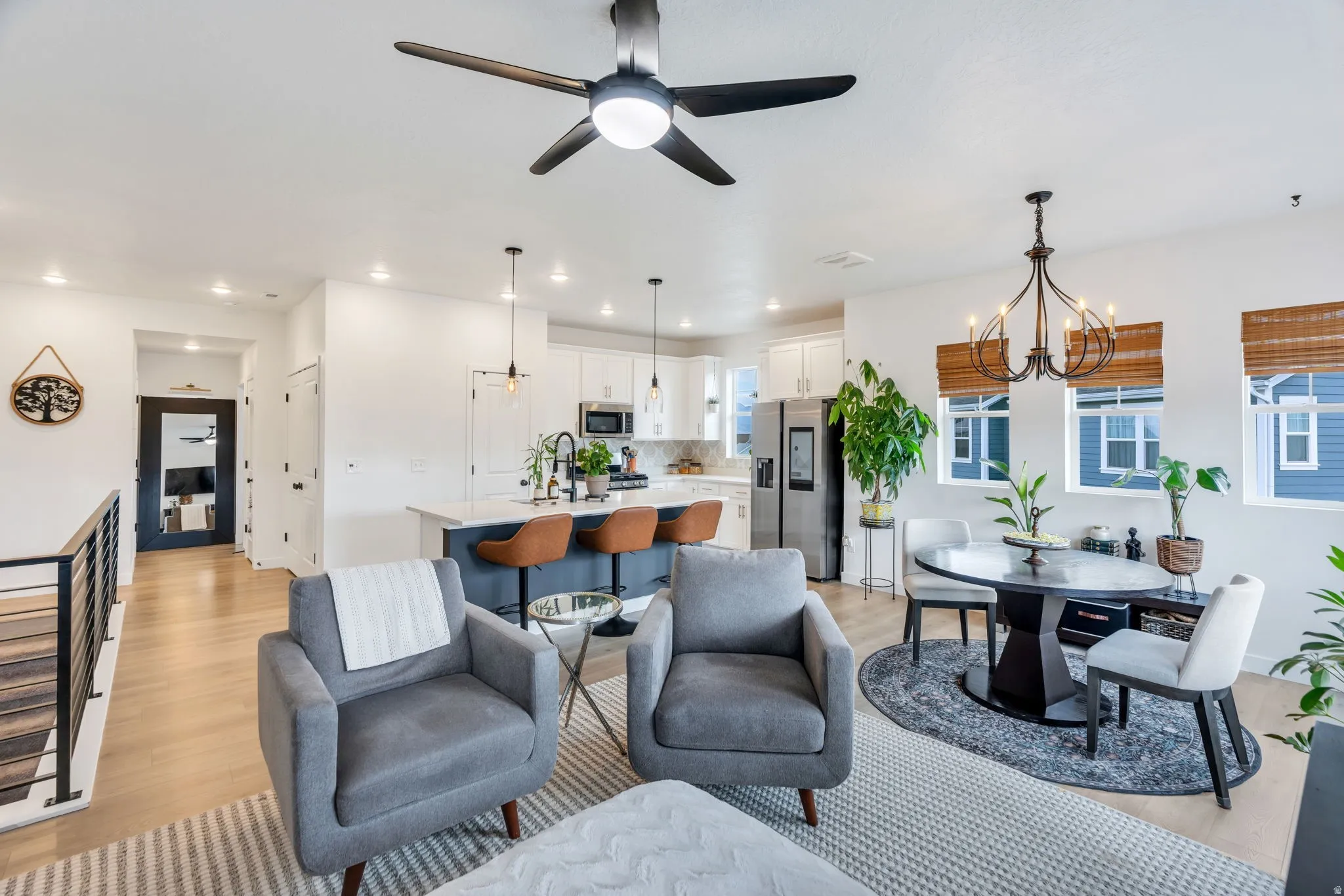 Open concept living space featuring wood-finish flooring, recessed lighting, and a contemporary ceiling fan