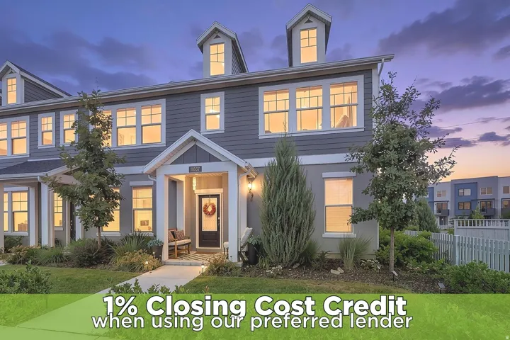 Multi-level townhome featuring dormer windows, a covered entry, and horizontal siding