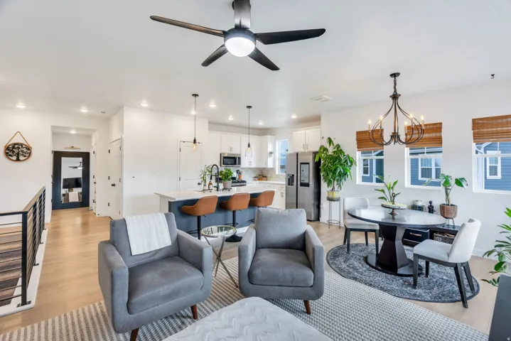 Open concept living space featuring wood-finish flooring, recessed lighting, and a contemporary ceiling fan