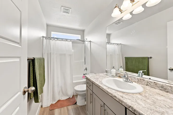 Vanity with a single basin sink, chrome faucet, and expansive counter space
