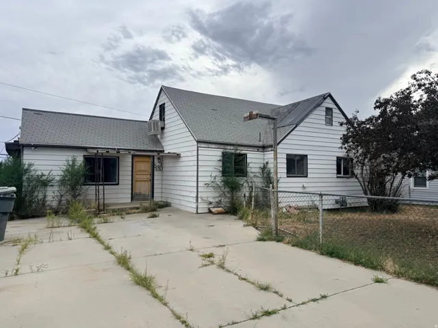 White siding exterior with a light grey shingle roof and a concrete driveway