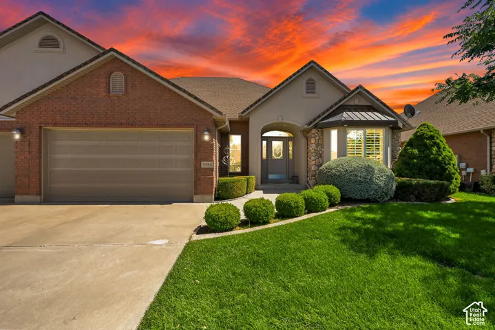 Brick and stucco exterior with a prominent arched entry