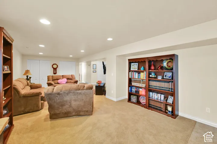 Recessed lighting, light-colored walls, built-in shelving, and carpeted flooring