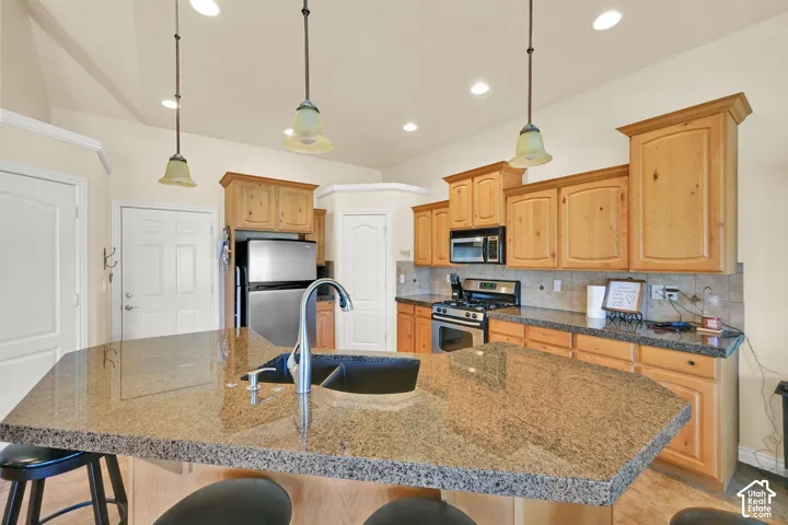 Kitchen island with a granite countertop and an undermount sink