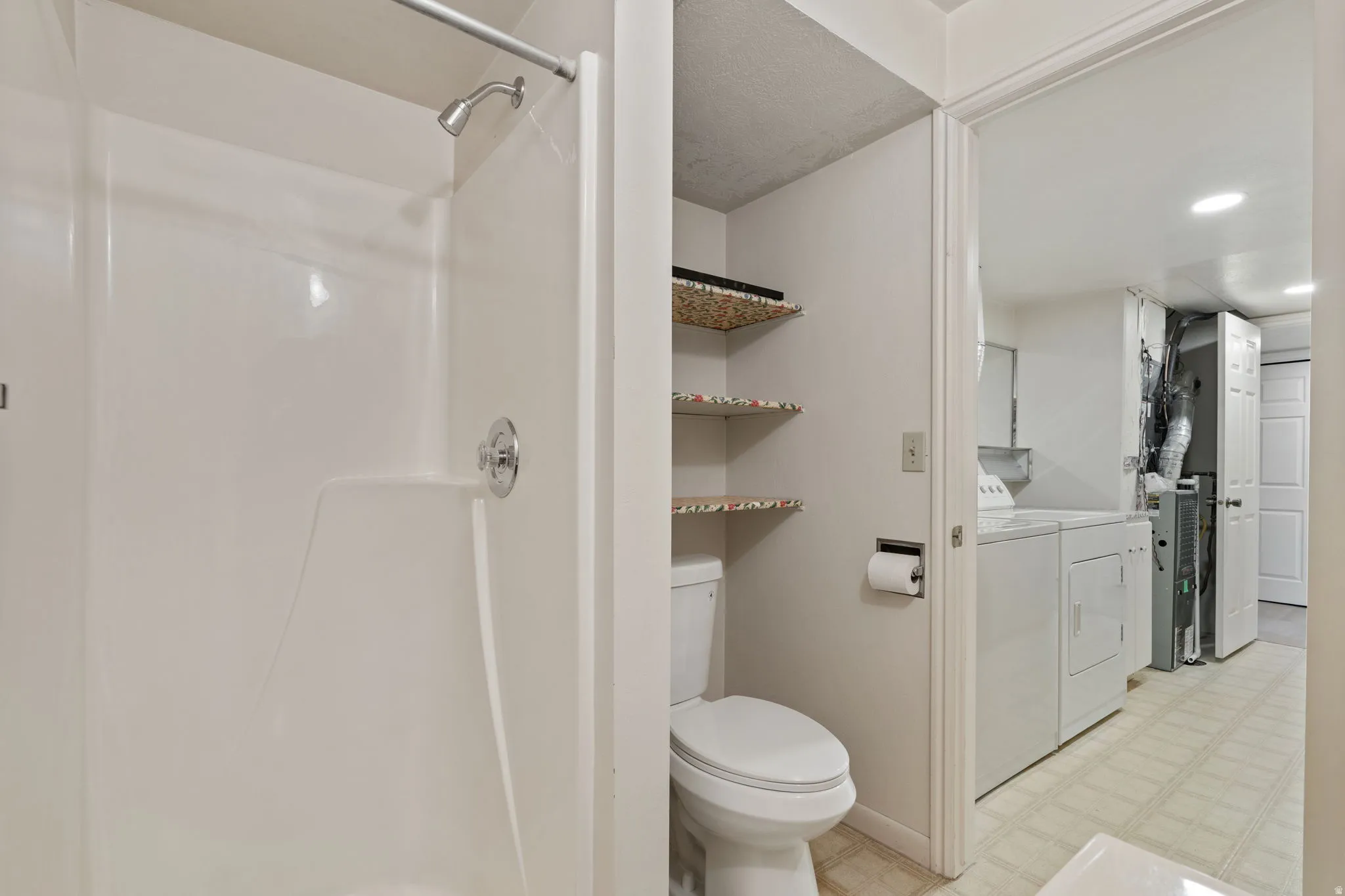 White shower enclosure with chrome fixtures