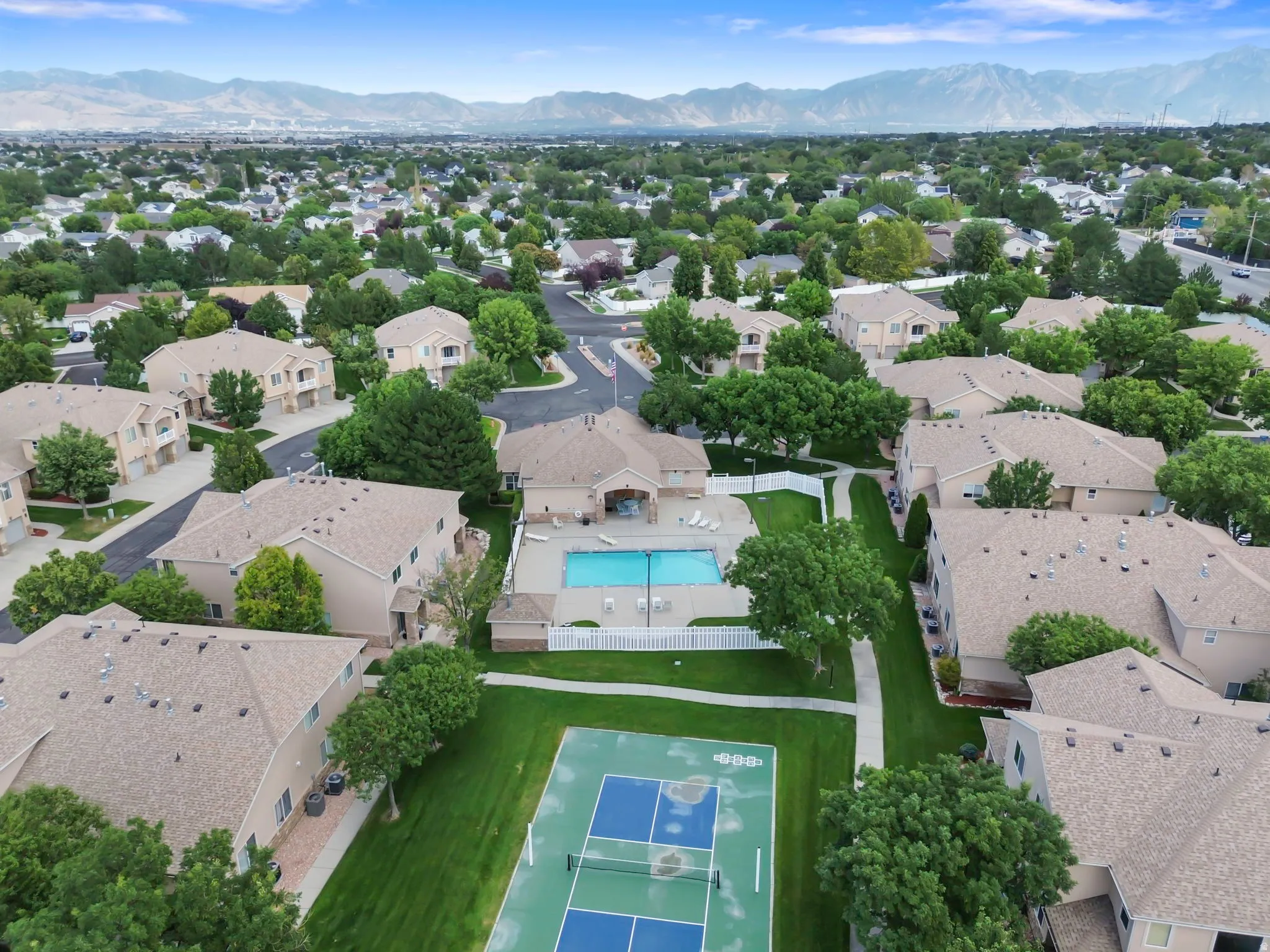 Community grounds featuring a tennis court, swimming pool, and dedicated pathways