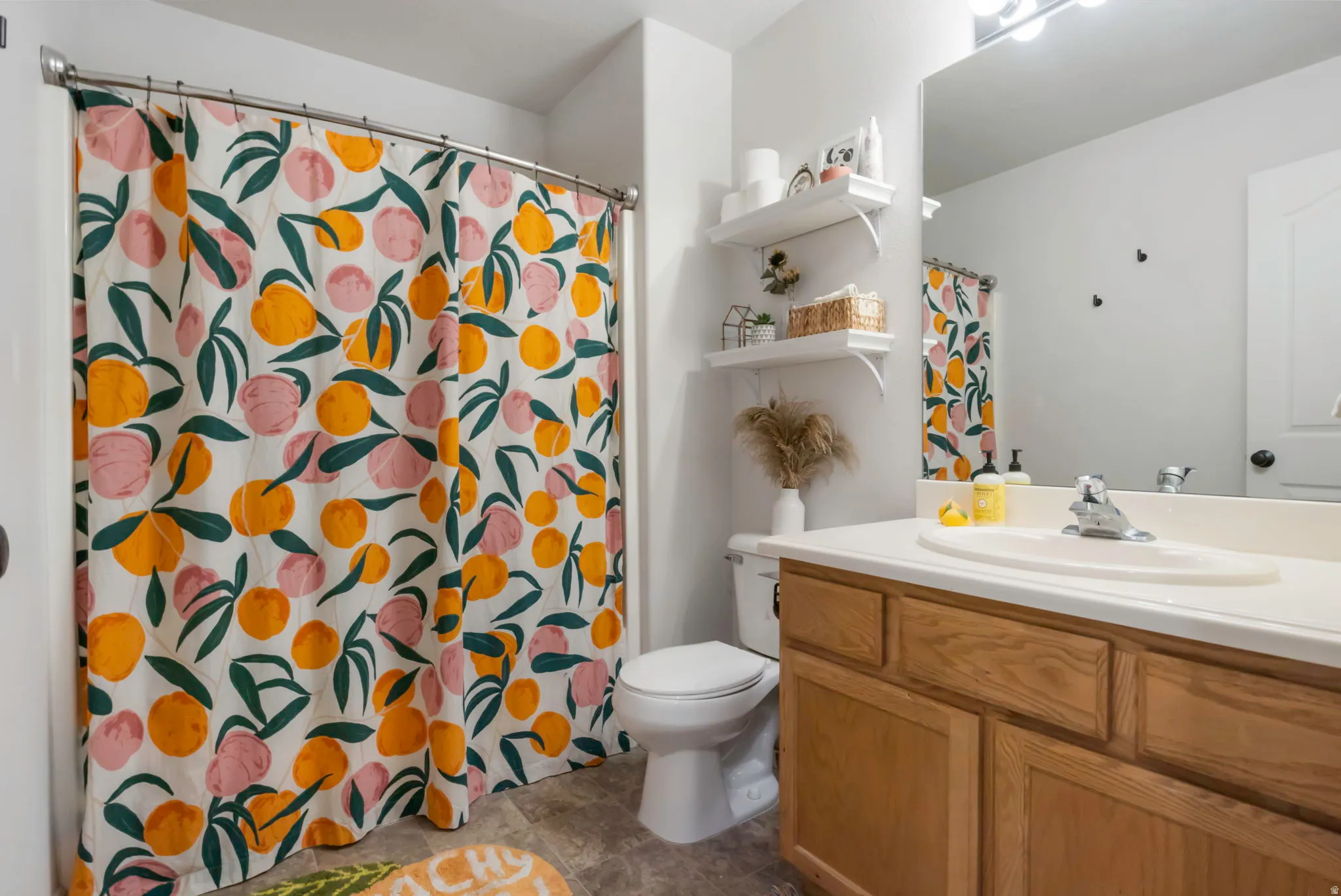 Hallway bathroom featuring vanity and bathtub/shower combo