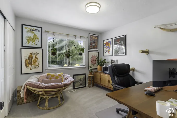 Bedroom being used as an office with recessed lighting, large window with blinds