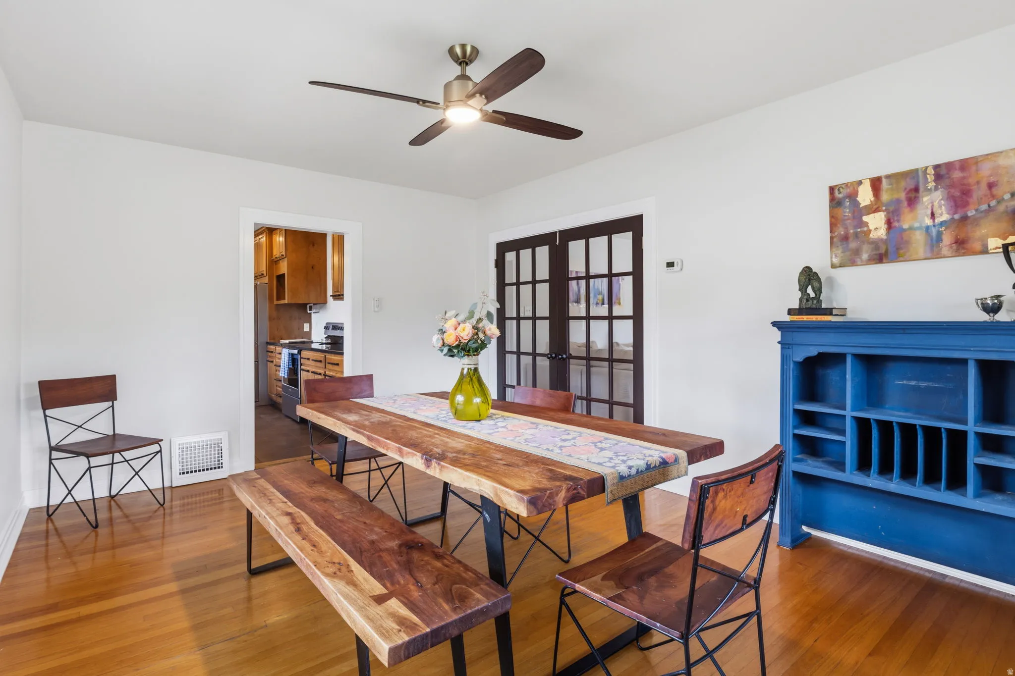 Hardwood flooring throughout, with a ceiling fan and recessed lighting