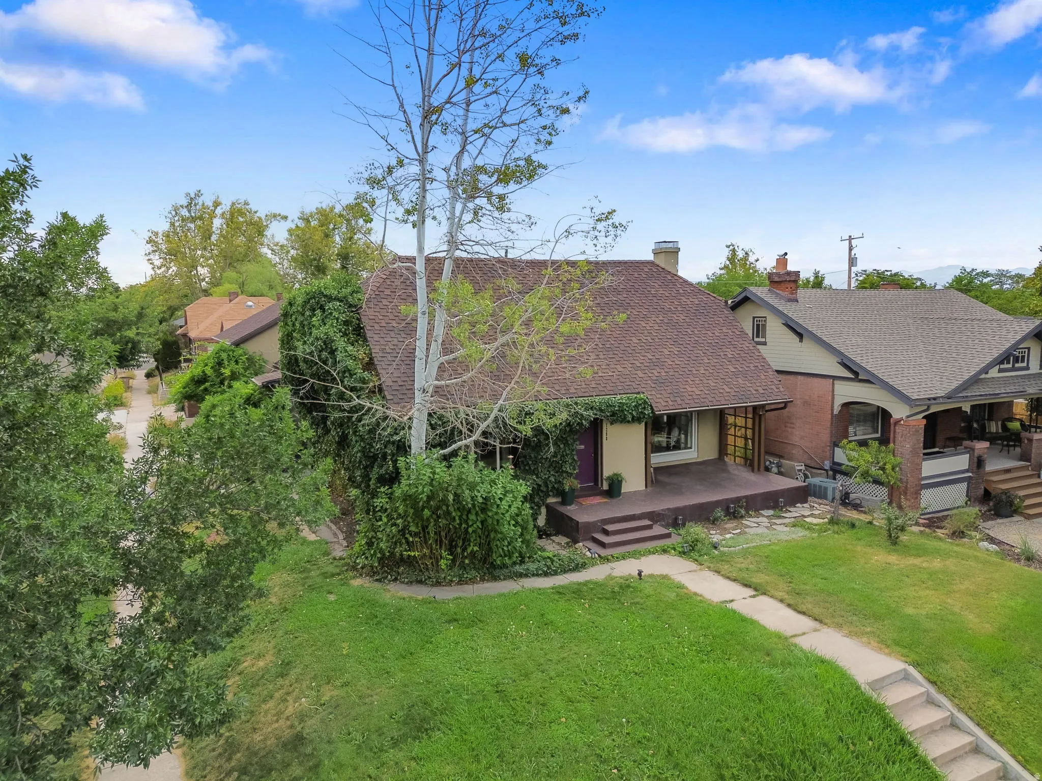 Gable roofline, mature trees, and established landscaping