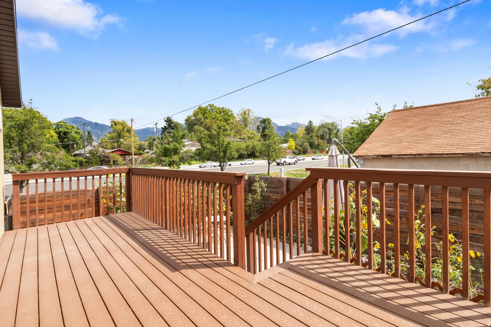 Expansive outdoor deck with wood-finish railing and decking