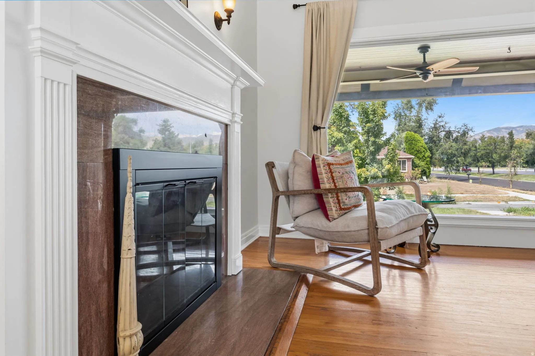 Fireplace with a white mantel and stone surround