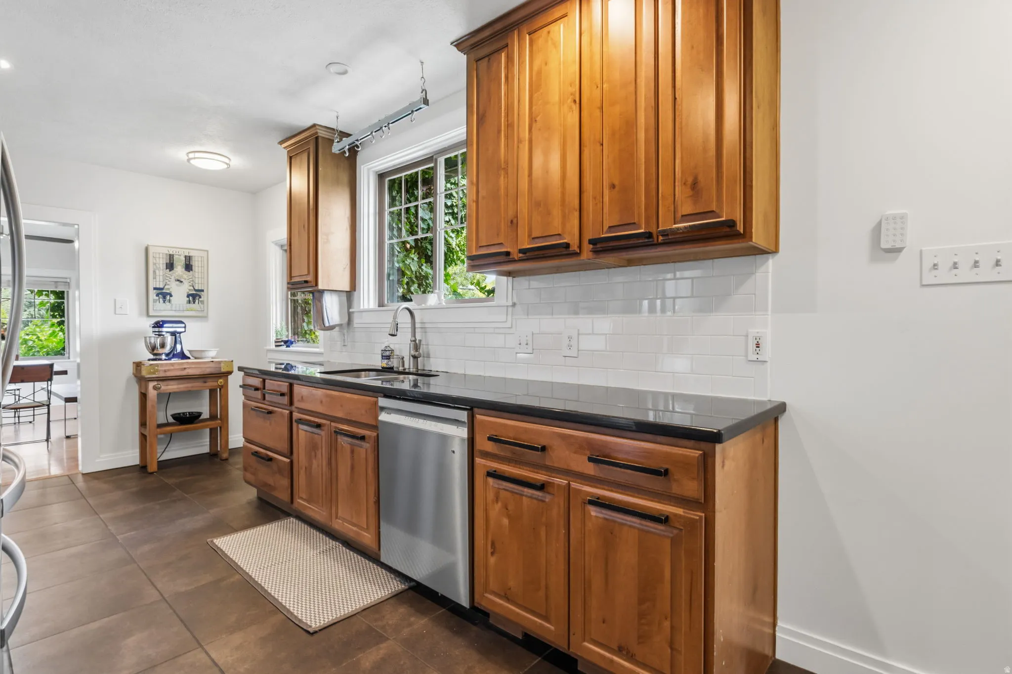 Warm wood cabinetry with dark hardware