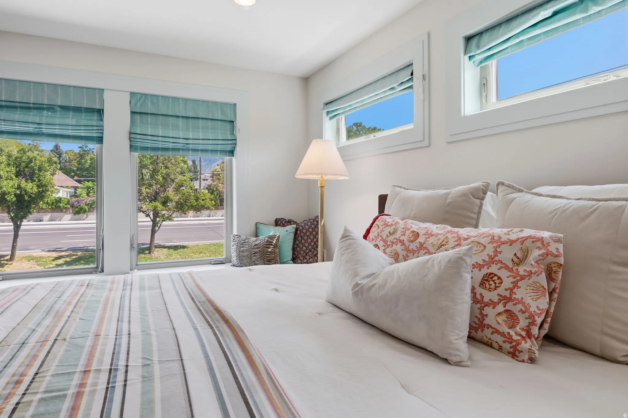 Primary suite with Expansive windows with custom window treatments