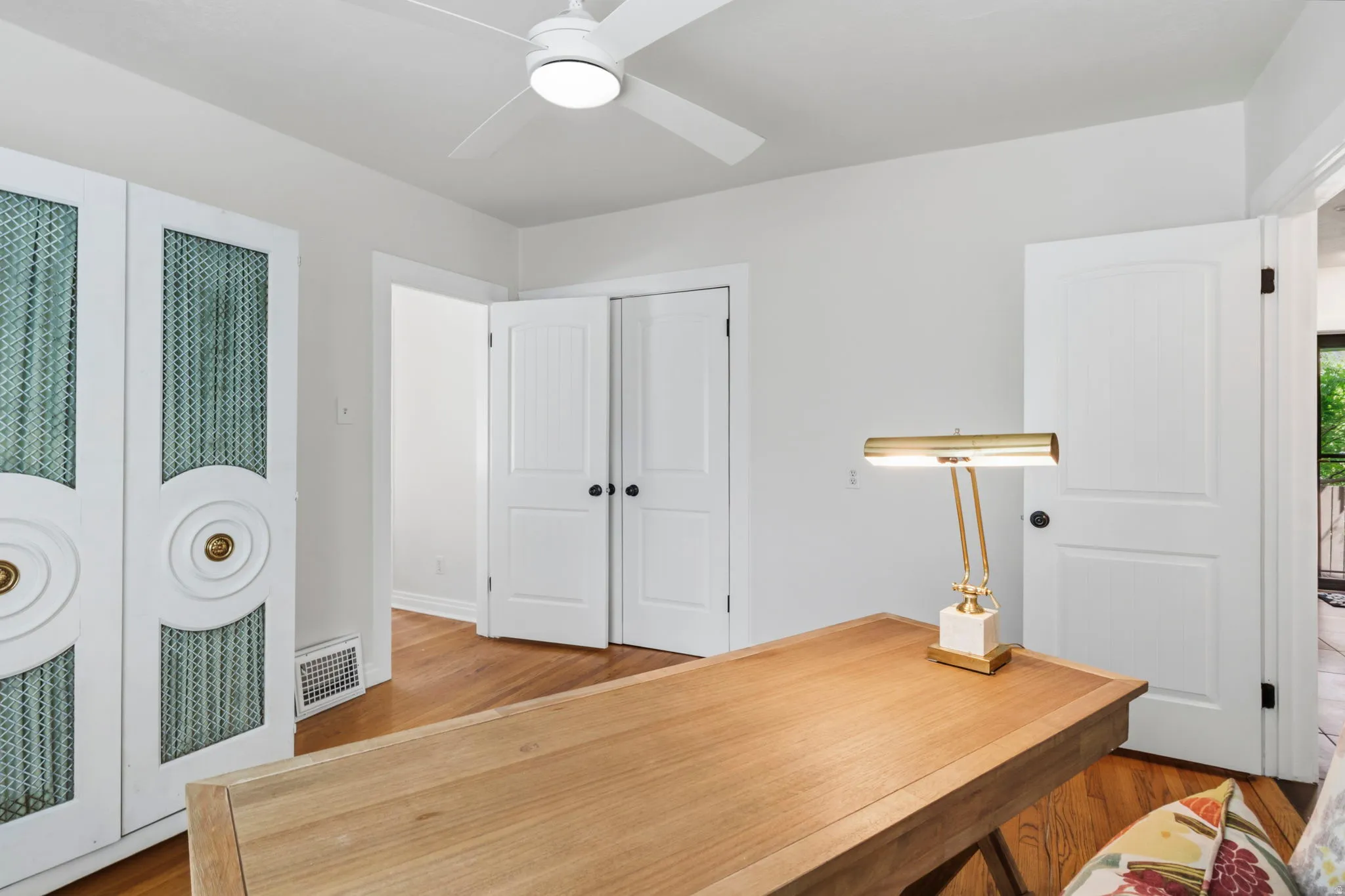 Bedroom 3 or office Hardwood flooring and white paneled doors