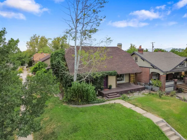 Gable roofline, mature trees, and established landscaping