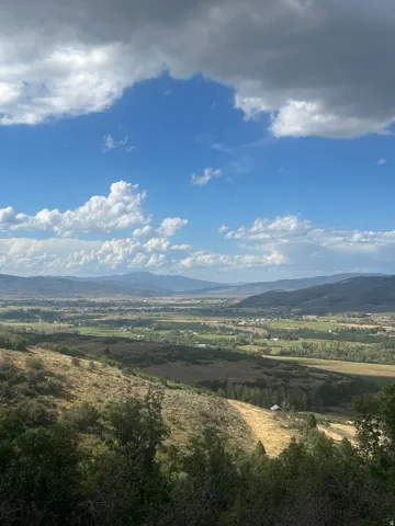 Expansive valley scenery with distant mountains and varied terrain