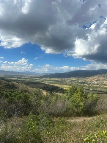 Expansive valley scenery with distant mountains and natural foliage
