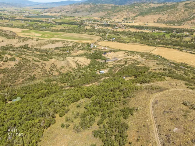 Expansive natural landscape with varied topography, including wooded areas and open terrain