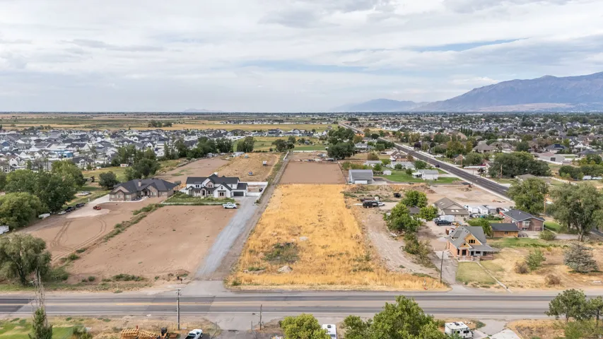 Expansive undeveloped land parcels with established residential structures nearby