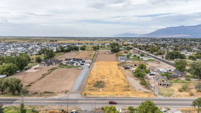 Expansive raw land parcels with mountain backdrop and established residential areas