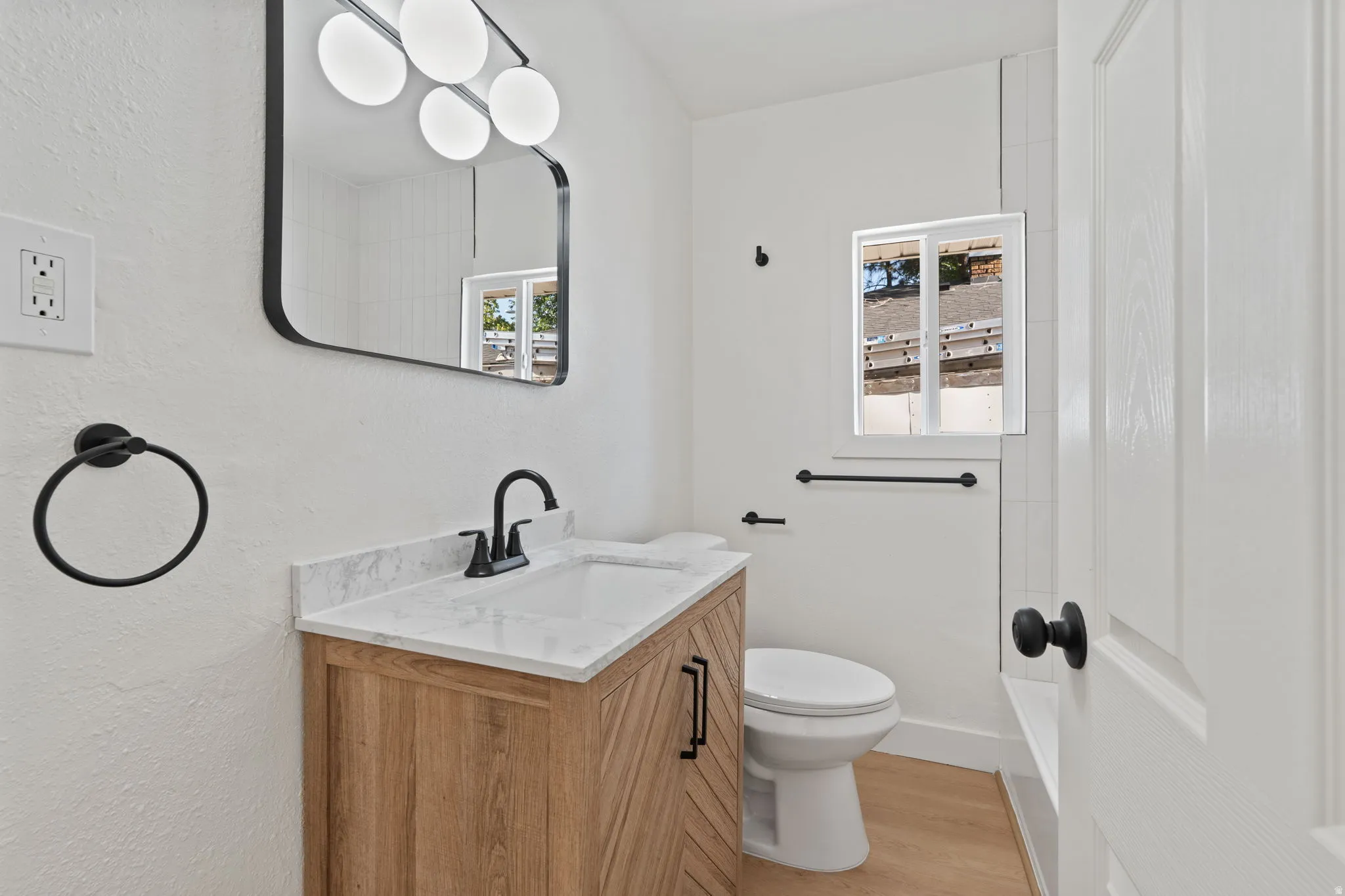 Wood-finish vanity with a white countertop and integrated sink