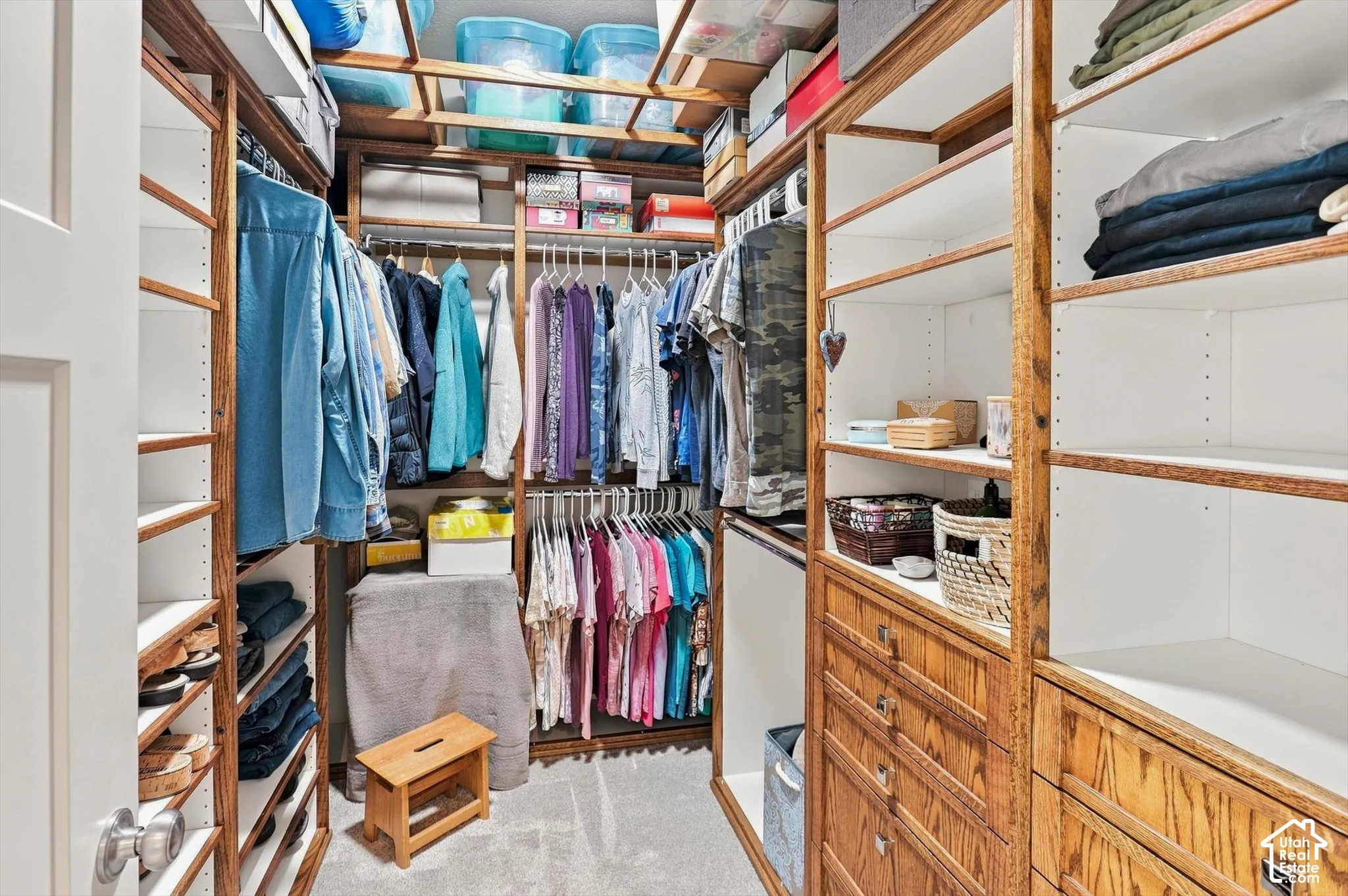 Custom closet system featuring wood-finish framing, integrated shelving, and built-in drawer storage