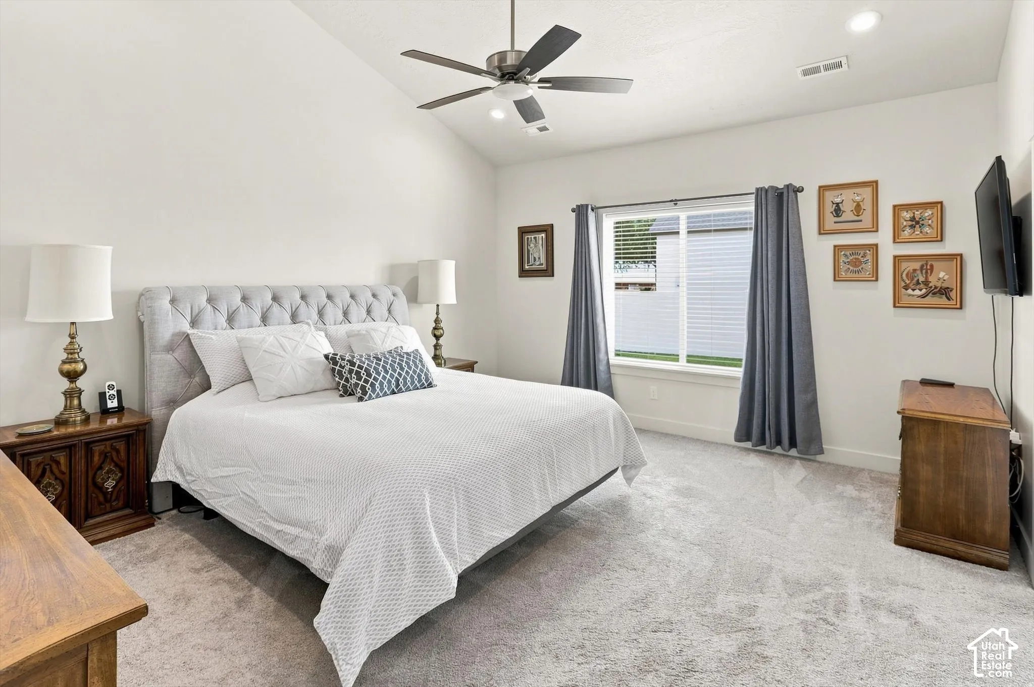 Vaulted ceiling with a ceiling fan, recessed lighting, carpet flooring, and a large window
