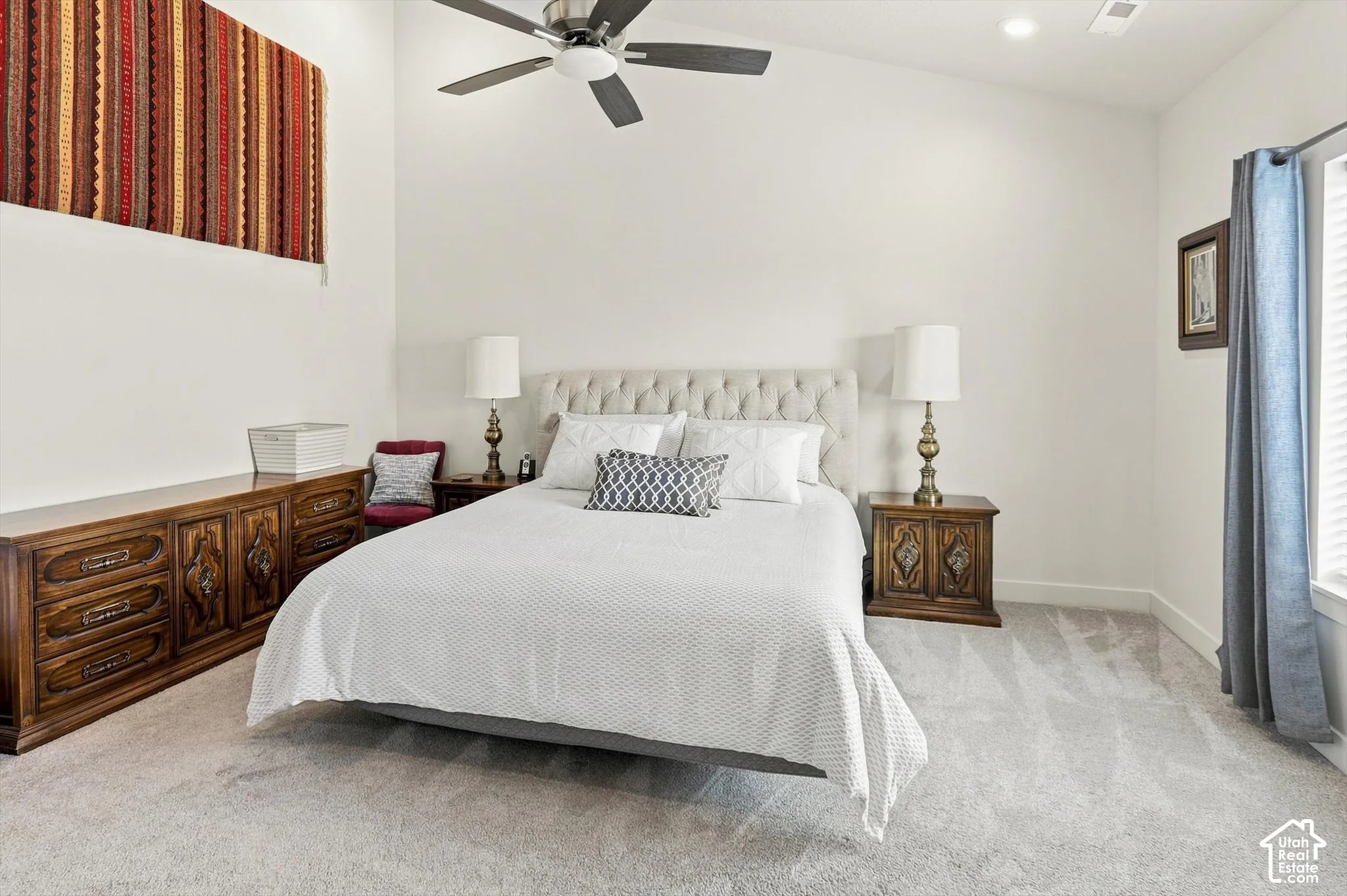 Vaulted ceiling, light-toned carpeting, ceiling fan, recessed lighting, and a window with blinds