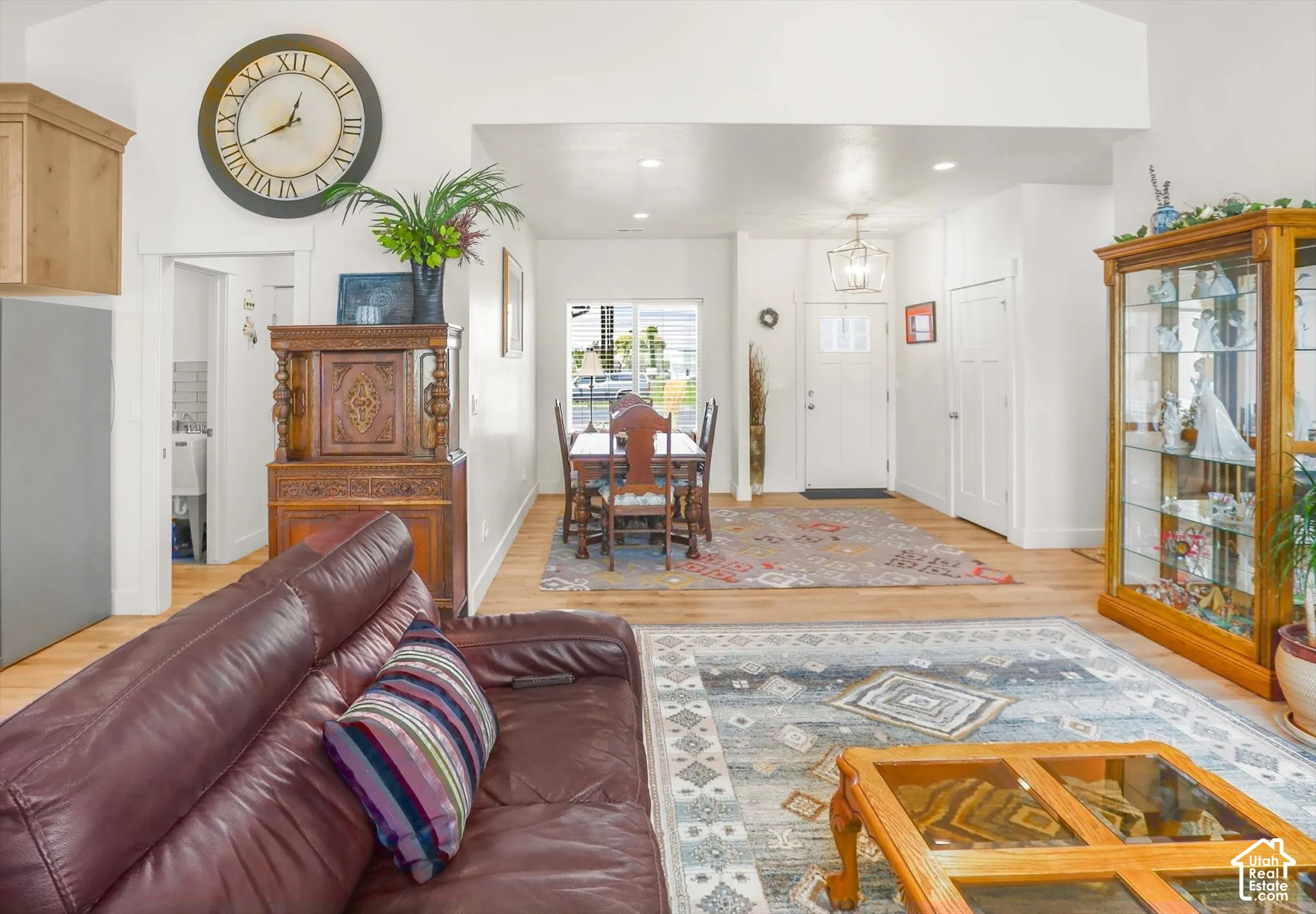 Wood-finish flooring throughout, vaulted ceiling, and recessed lighting