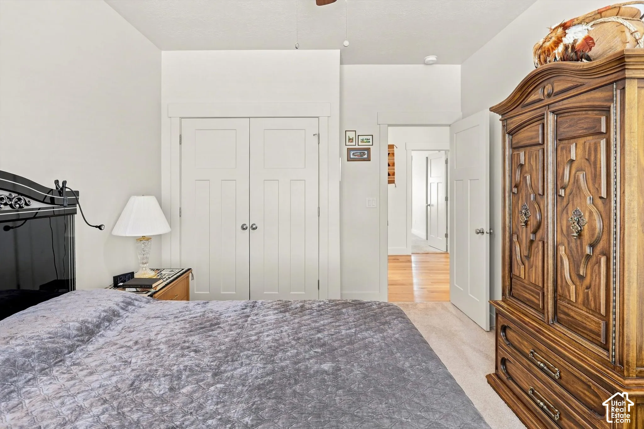 Carpeted flooring, white trim, recessed lighting, and a paneled door