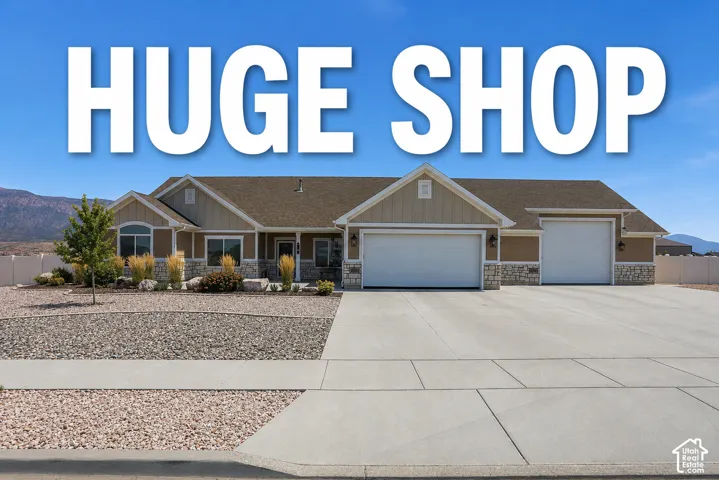 Real Estate Marketing Image. Exterior view of the property with text overlay highlighting a "HUGE SHOP"