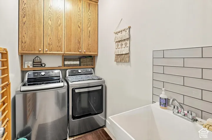 Built-in cabinetry with wood-finish doors, open shelving, and a utility sink with a tiled backsplash