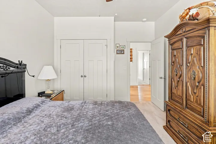 Carpeted flooring, white trim, recessed lighting, and a paneled door
