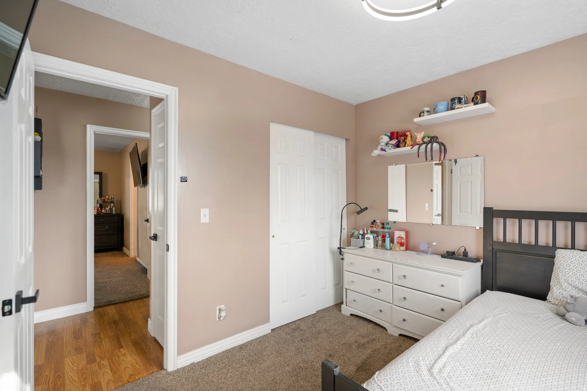 Wall-to-wall carpeting, neutral wall color, and white trim
