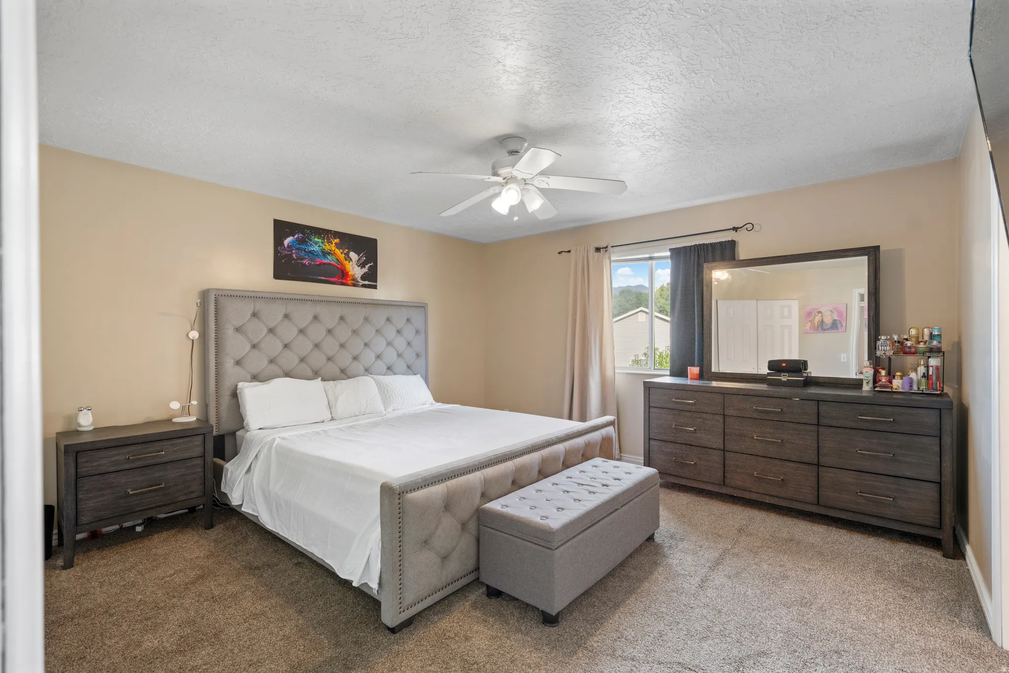 Ceiling fan, window with exterior view, and wall-to-wall carpeting