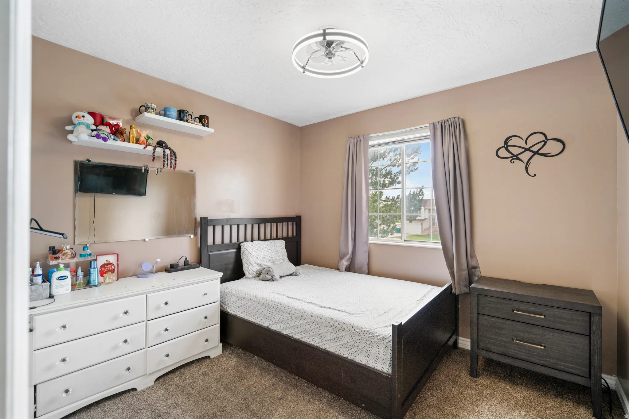 Window with natural light, wall-to-wall carpeting, and a ceiling fan with integrated lighting