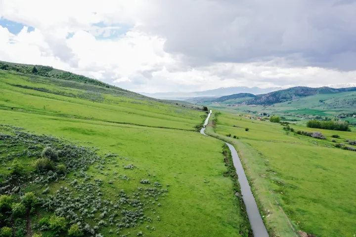 Expansive green hillsides and distant mountains