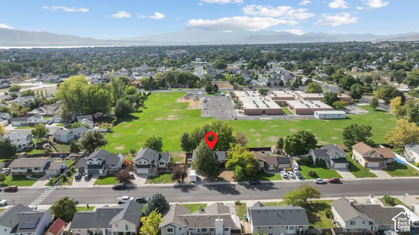 Residential neighborhood setting with mature trees and a substantial green space