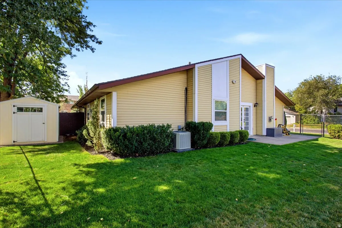 Yellow siding exterior with white trim accents and a brown roof