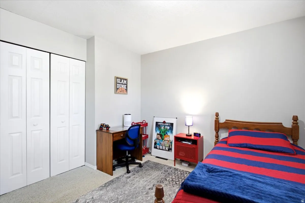 Light-colored walls, carpet flooring, and bi-fold closet doors