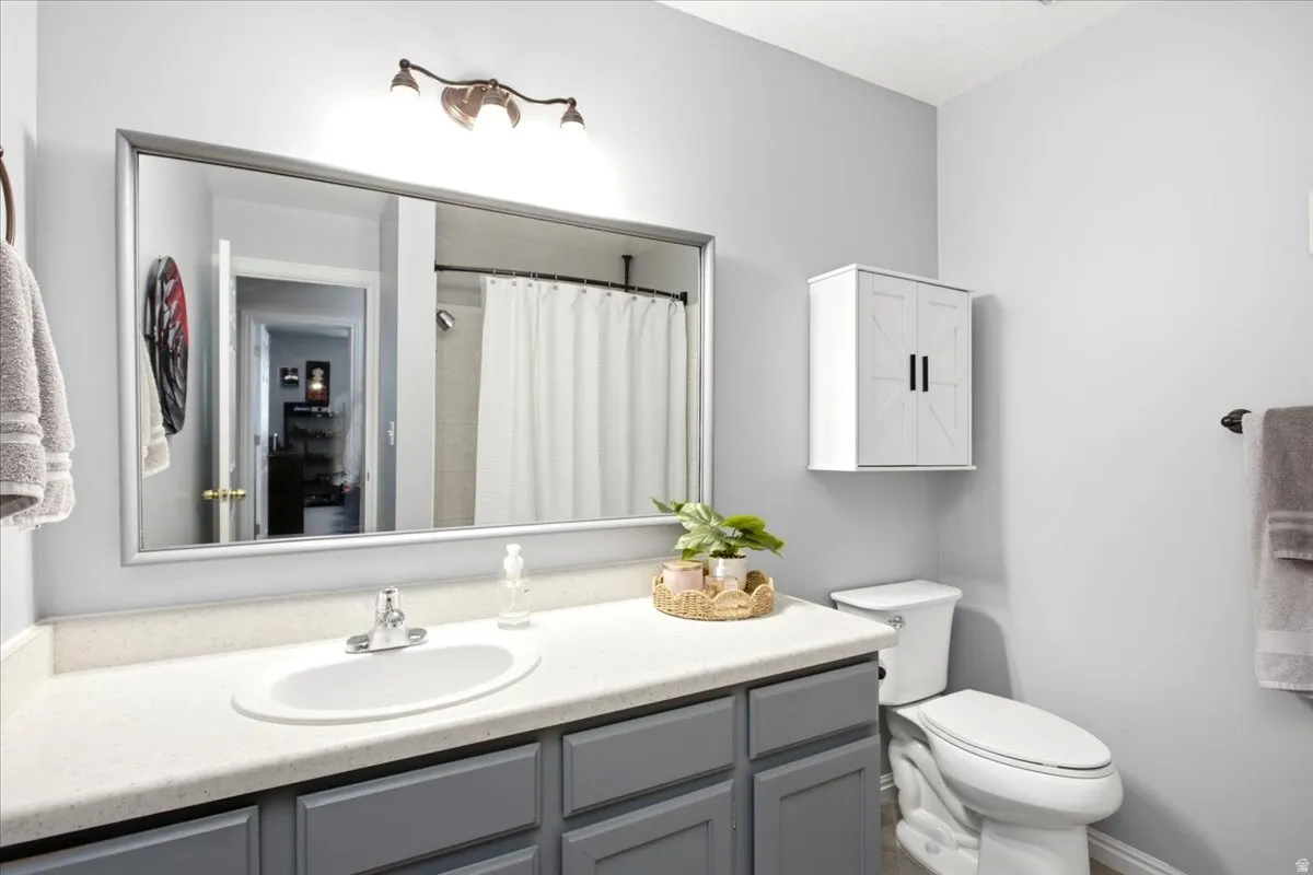 Vanity with an integrated sink, brushed nickel faucet, and gray cabinetry